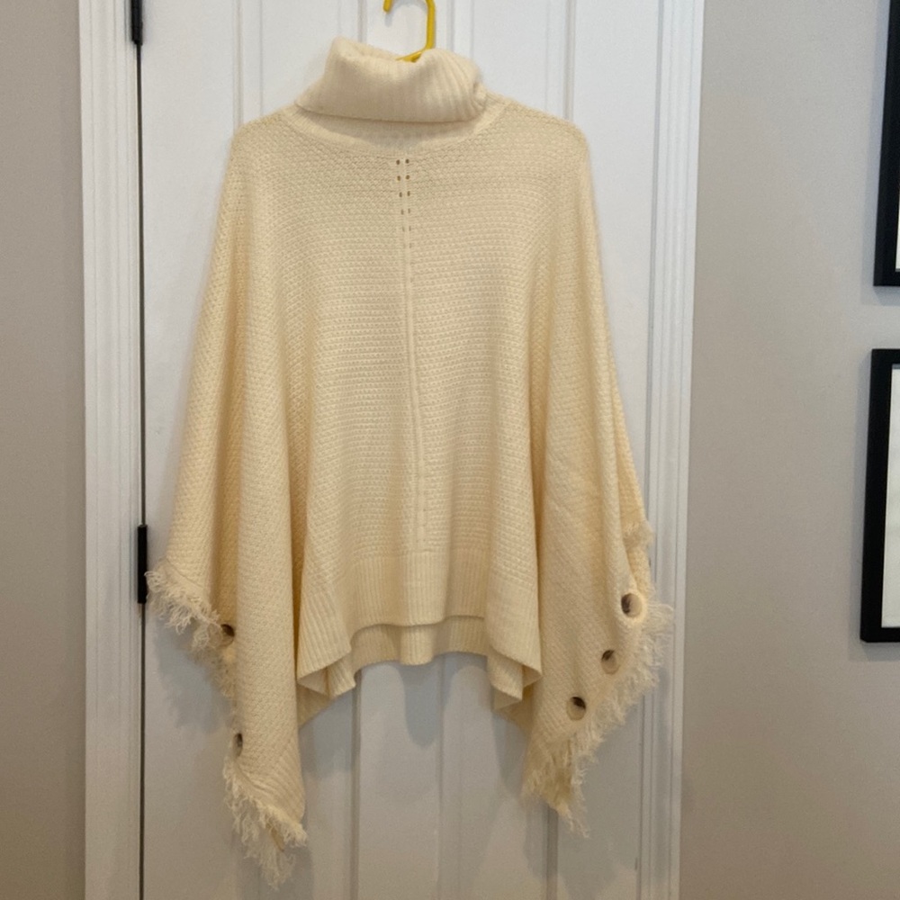 Cute never worn cream poncho with brown buttons!
